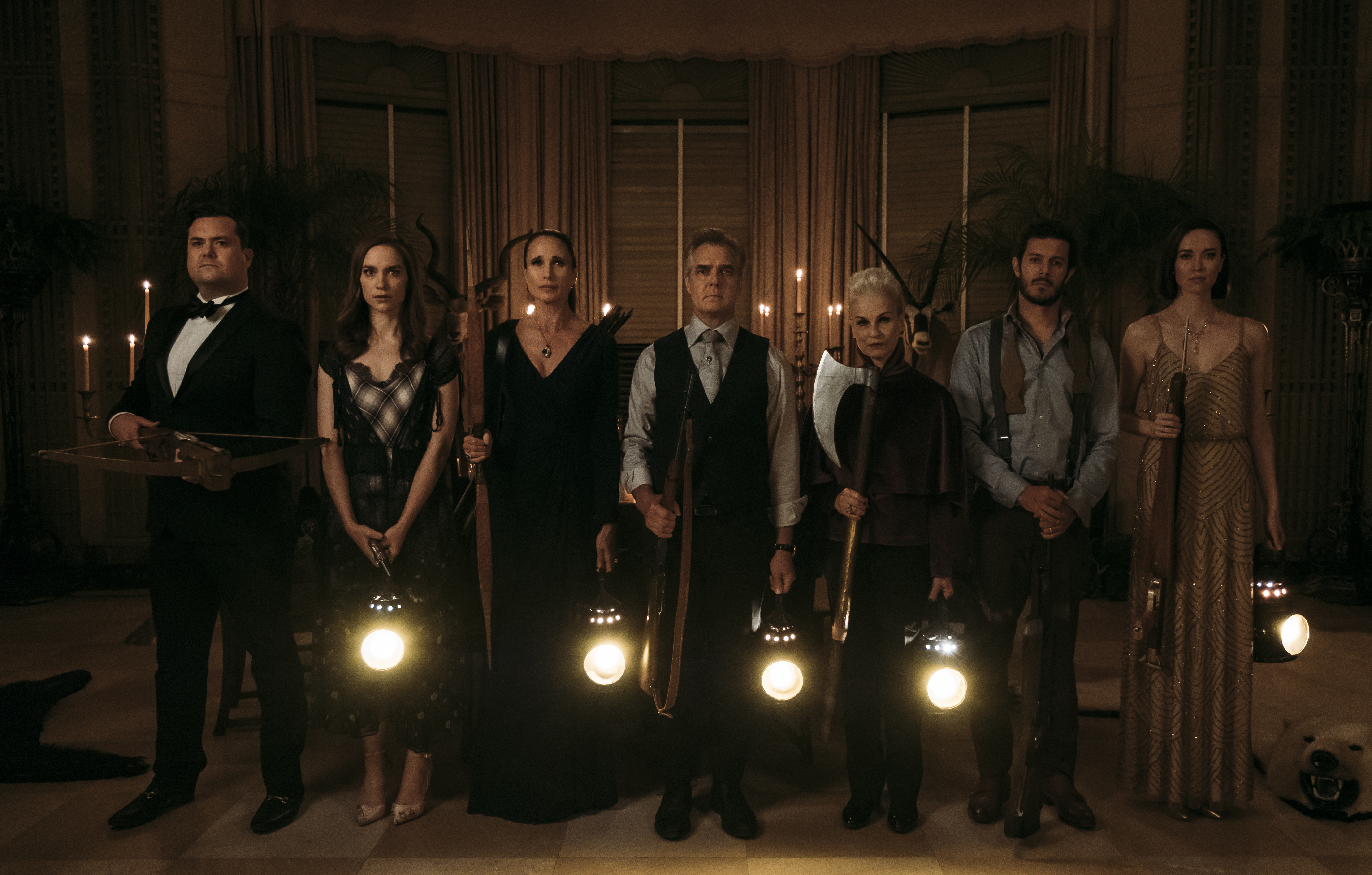 (From L-R:) Kristian Bruun, Melanie Scrofano, Andie MacDowell, Henry Czerny, Nicky Guadagni, Adam Brody, and Elyse Levesque in the film READY OR NOT. Photo by Eric Zachanowich. © 2019 Twentieth Century Fox Film Corporation All Rights Reserved